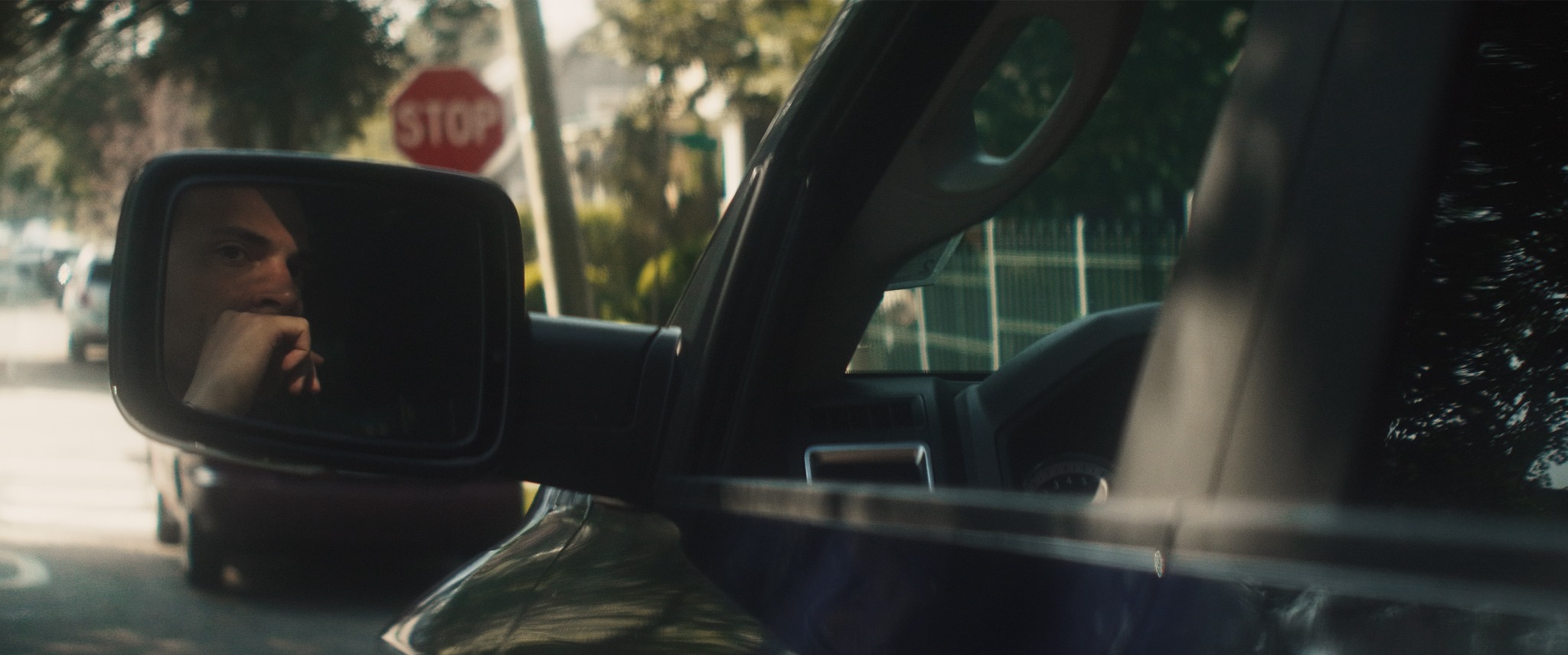 Michael seen in a car mirror